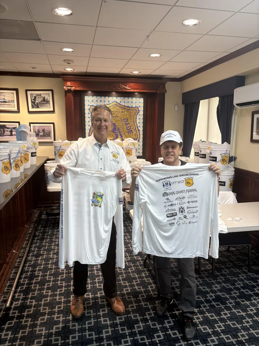 South Florida Police Benevolent Association members holding Goldcoast Marketing Group printed fishing tournament shirts